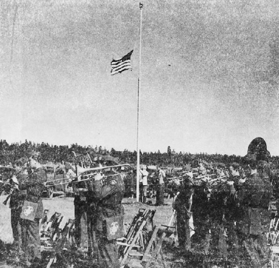 Image: The Marine Corps band plays the national anthem as the flag is raised at the dedication of Ray Enouf Field, Klamath Agency, Oregon. The airfield is named in honor of the only Klamath Indian to lose his life in World War II, a Marine private first class, who was killed while acting as first-aid man in the front lines on Iwo Jima. Ceremonies dedicating the field took place on September 27, 1945. 