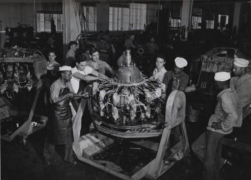"'Naval Air Station, Kaneohe Bay, Territory of Hawaii' - Teaming up to put this high powered airplane engine into fighting condition are Seaman First Class Joseph T. Kilpatrick, John R. Bohr, Arthur McIntosh, Frank Mendes, Jr. and Seaman First Class Fadis Jones."