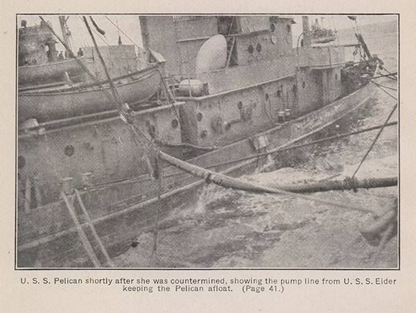U. S. S. Pelican shortly after she was countermined, showing the pump line from U. S. S. Eider keeping the Pelican afloat. (Page 41.)