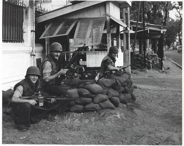 US Navy personnel attached to Commander Naval Forces Vietnam, keep their guns ready as they watch during Viet Cong attacks on Saigon. Photo taken in February 1968. Photo by PH1 G.D. Olson. Naval Historical Center Photographic Branch collection, #USN 1129709.