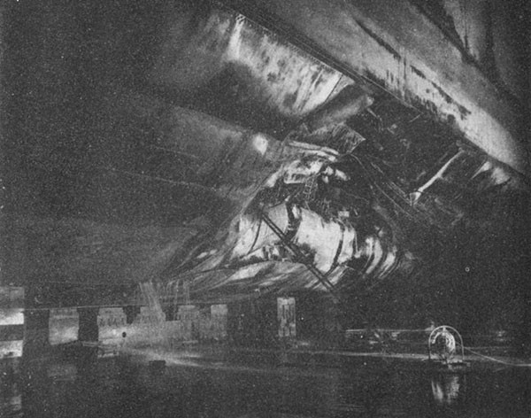 Photo 25: CANBERRA (CA 70) Looking forward at torpedo damage.