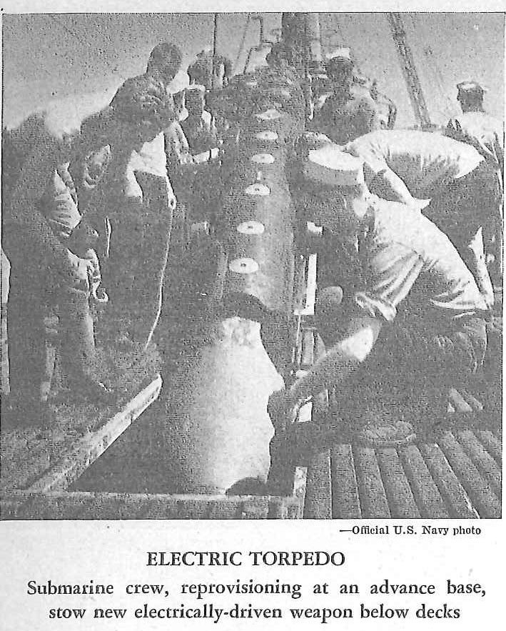 ELECTRIC TORPEDO Submarine crew, reprovisioning at an advance base, stow new electrically-driven weapon below decks
