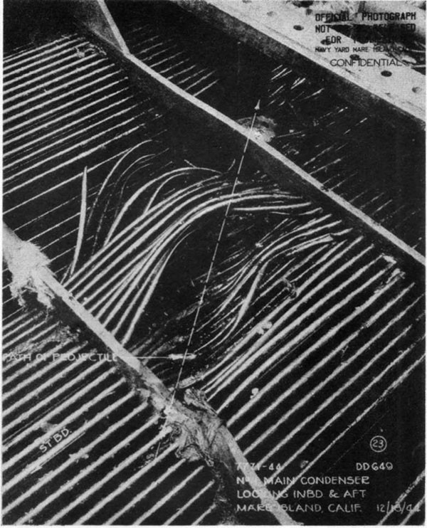 Hit #3. Damage to forward main condenser caused by dud 6-inch AP projectile which entered the tube nest after passing through the skirt of the L.P. turbine and fracturing the lower casing.