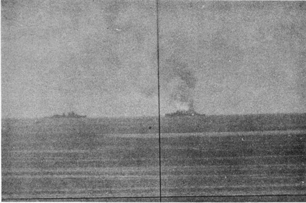 ABNER READ (DD526). View taken shortly after Kamikaze hit showing blaze in way of No. 3 upper handling room. Ship standing by is CLAXTON.