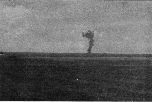 ABNER READ (DD526). Column of smoke rising following handling room explosion about ten minutes after Kamikaze crash.