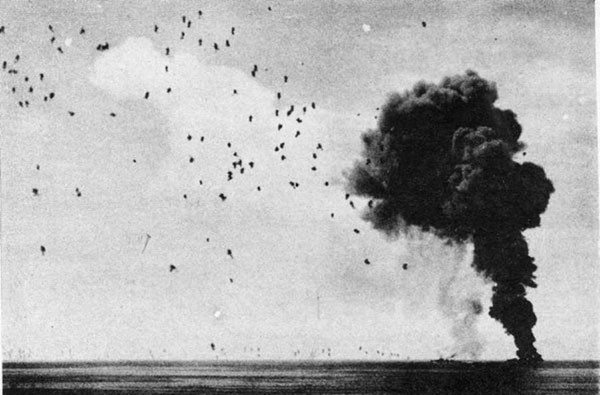 ABNER READ (DD626). View shortly before ship sank. Black smoke is probably due to oil fire which continued to burn long after ship disappeared. Anti-aircraft puffs are from gunfire directed at third Kamikaze, shot down about 25 minutes after ABNER READ was hit.