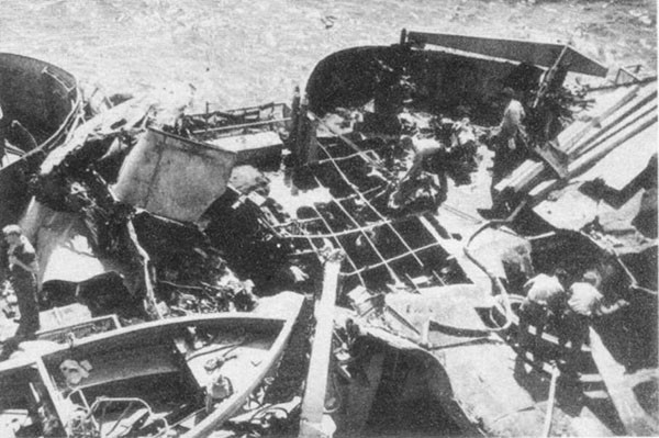 HUGH W. HADLEY (DD774). View of midship deckhouse, frames 130 to 150, in way of third Kamikaze crash and ensuing fire. Plane hit at base of director tower, left center, bomb at 40mm mount No. 4, lower right.