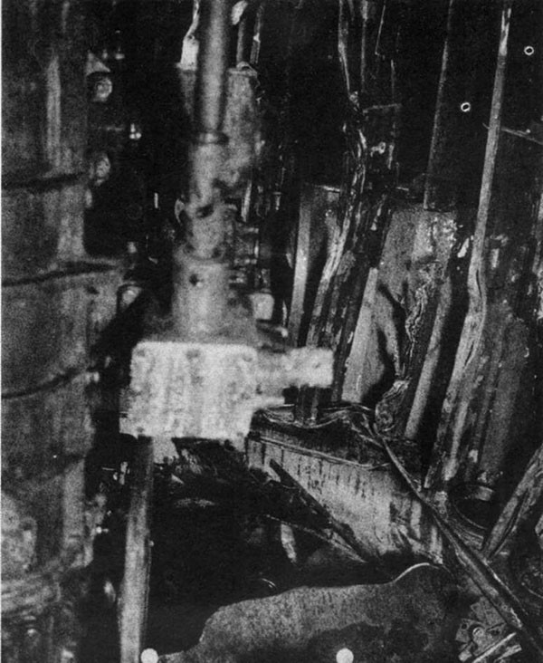 STORMES (DD780). Fire and blast damage in upper handling room for No. 3 mount. Powder charges, stowed vertically between uprights, were heavily attacked by fragments and largely burned out.