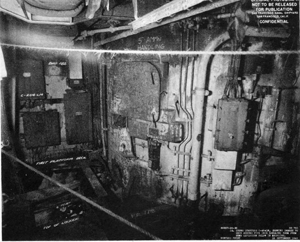 STORMES (DD780). First platform deck starboard looking aft abreast barbette for No. 3 mount showing fire and blast damage after removal of debris and installation of temporary structure.
