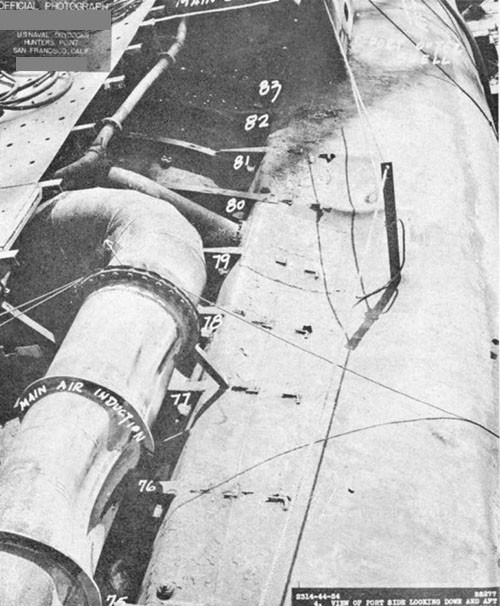 Photo 9-6: SCAMP (SS277). View of port side, looking down and aft, showing partial collapse of the engine air induction piping.