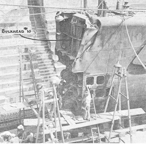 Photo 13-3: GROWLER (SS215). Port side view in Moreton Drydock, Brisbane. Most of damaged bow has been removed.