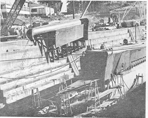 Photo 13-7: GROWLER (SS215). Upper horizontal section of prefabricated bow being erected. Lower section already welded in place. Ship is in Moreton Drydock, Brisbane.