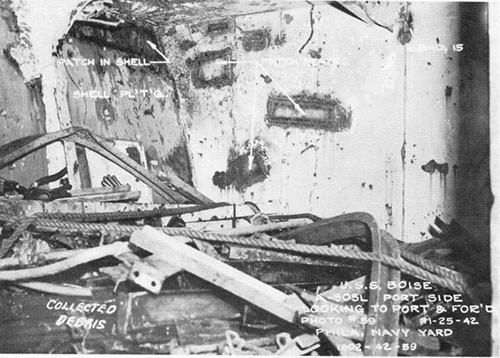 Photo 22: Fragment damage on port side of third deck -opposite hit. The debris in the foreground was collected and stored here as scrap.