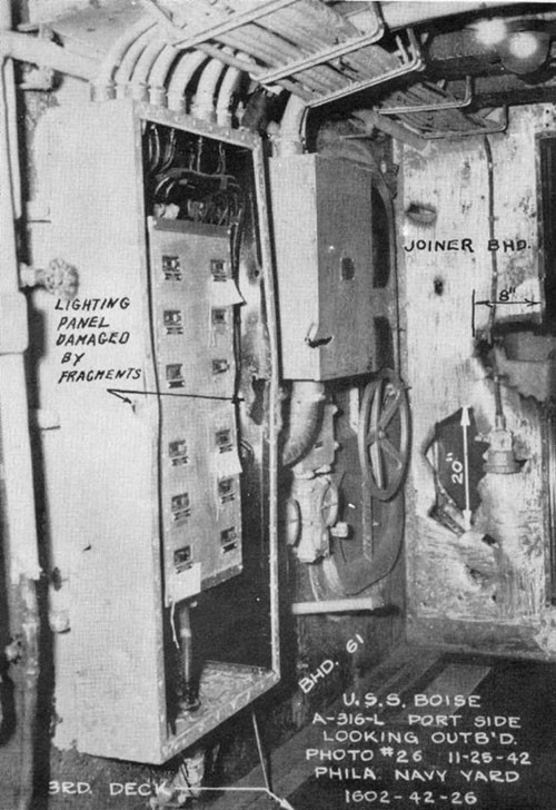 Photo 6: Lighting panel damaged by splinters, and holes in bulkhead of overcoat locker.