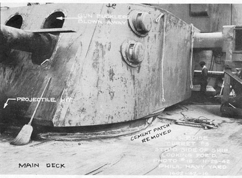 Photo 7: Showing hit on face plate of turret III and damage done to main deck.