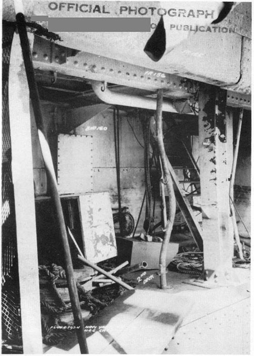 Photo 11: Starboard side view of open flat. Note buckling of wire mesh bulkhead stanchion, berth stanchions, and heavy centerline stanchion. (U.S.S. CAPELLA).