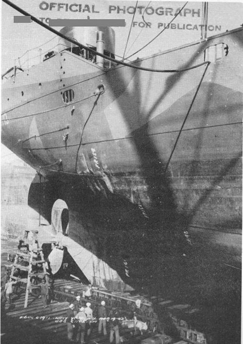 Photo 13: Damage to starboard side plating and bulwark at after end of after well deck. Note wrinkle carrying up side plating to main deck. (U.S.S. CAPELLA).