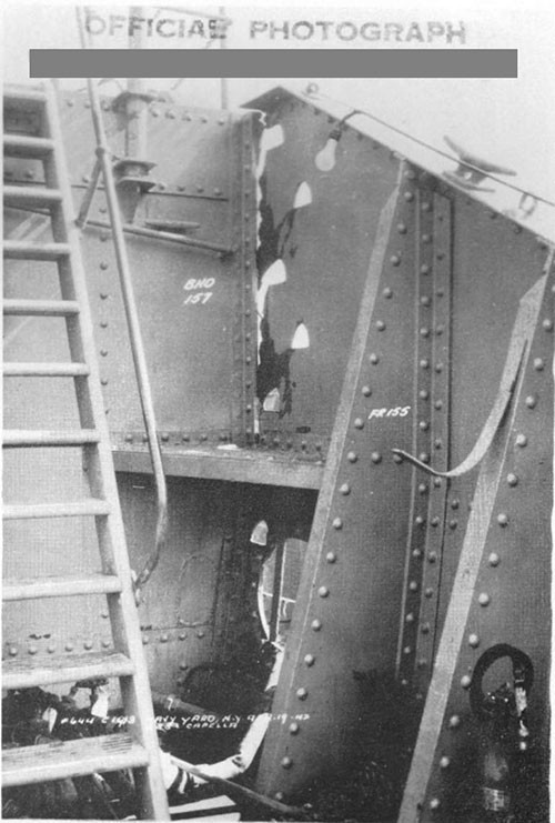 Photo 15: Damage to port bulwark at after end of after well deck. Note fracture of bulwark along boundary angle at frame 157. (U.S.S. CAPELLA).