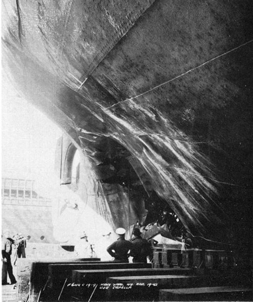 Photo 4: Torpedo damage to port shell, looking aft. Note wrinkle in shell plating between frames 159 and 160. (U.S.S. CAPELLA).