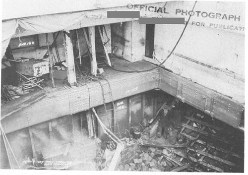 Photo 10. Damage to bulkhead 156 and to open flat on second deck, looking aft and to port.