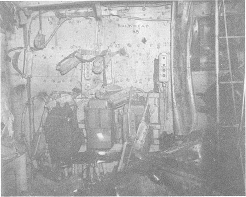 Photo F-8: Second hit. Third deck near point of detonation of main portion of bomb in A-306-L.