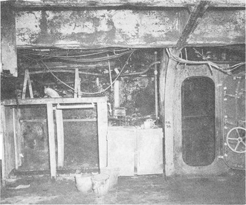 Photo J-17: View of ready powder locker on inboard bulkhead of Group I 5-inch gun gallery, frame 36, gallery deck, starboard; scene of powder and electric fire.