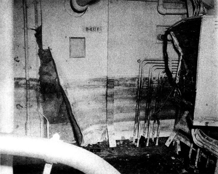 Photo 8: 30 October Action. View showing damage by vapor explosion to sheathing and bomb elevator machinery controller box in B-431-E. Note high-water mark.