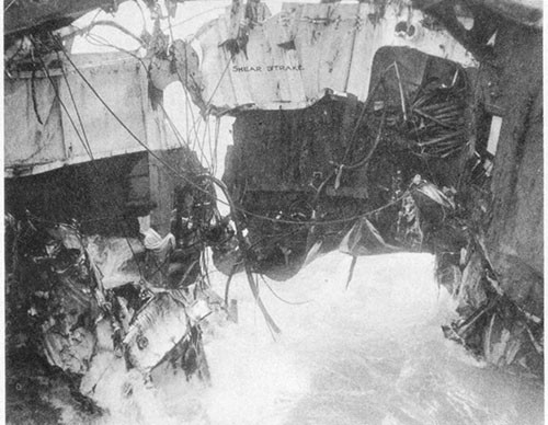 Photo No. 18: Looking outboard at damaged after section of hangar while en route to Ulithi. Note vertical split in shell plating and opening between the main deck and shell plating.