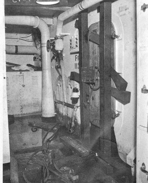 Photo 12: Compartment C-408-L. Note door 4-113-2 shored. Water on deck was from leaks through electric cable stuffing tubes and leakage at base of doors 4-113-2 and 4-113-1.