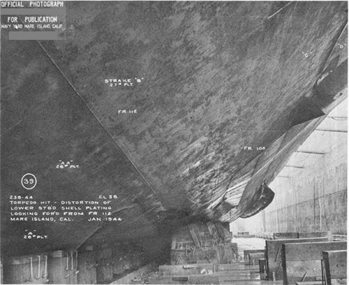 Photo 18: Looking forward on starboard side, showing indentation, in bottom plating. Temporary shell has been installed over opening.