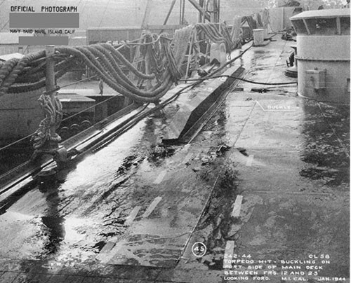 Photo 30: Port side main deck showing buckles in deck plating between frames 12 and 23. Note temporary stiffener.