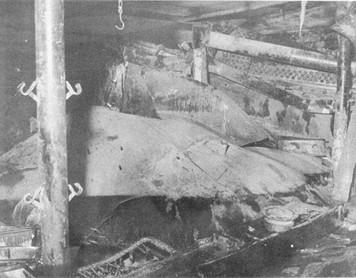 Photo 10: Compartment C-407-L. Looking forward and outboard to starboard side. The first platform deck is shown badly torn and crumpled.