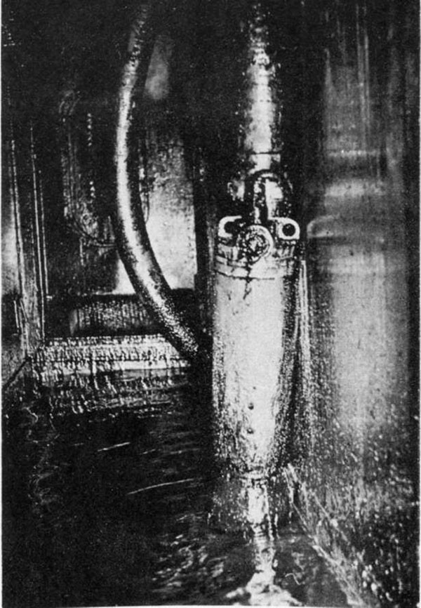 Photo 53. One of two portable submersible pumps in starboard side of A-310-1L with discharge hose leading to ventilation trunk and from thence to a ventilation opening in the second deck at frame 44, starboard.