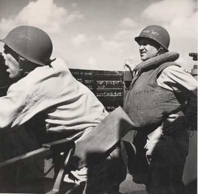 Image of Captain Dixie Kiefer (right), Commanding Officer, USS Ticonderoga (CV-14), on the bridge of his ship during an attack by Japanese planes off Manila, P.I., on 5 November 1944. Officer at left (unidentified) is taking bearings on the approaching planes. Photographic Section, Naval History and Heritage Command. Photo #: 80-G-469523.