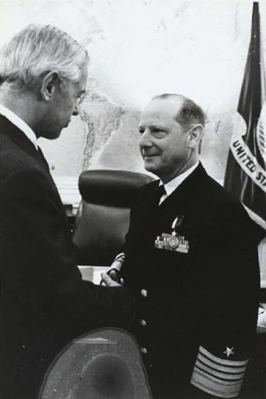 Secretary of the Navy, Paul H. Nitze congratulates Adm. Horacio Rivero, Vice Chief of Naval Operations, after presenting him a Distinguished Service Medal, for 