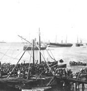 A photograph of transport ships unloading troops at Daiquiri.