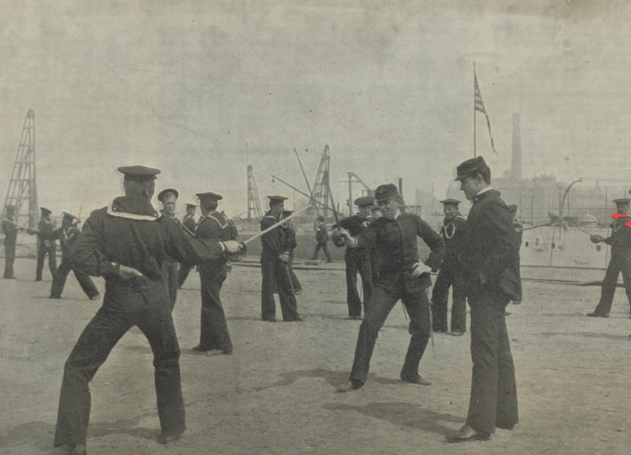 A photo of sailors practicing with cutlasses at a navy yard.