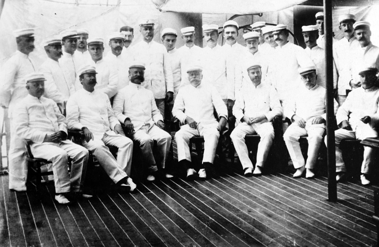 A picture of Commodore George Dewey and his officers  on the deck of the Olympia.