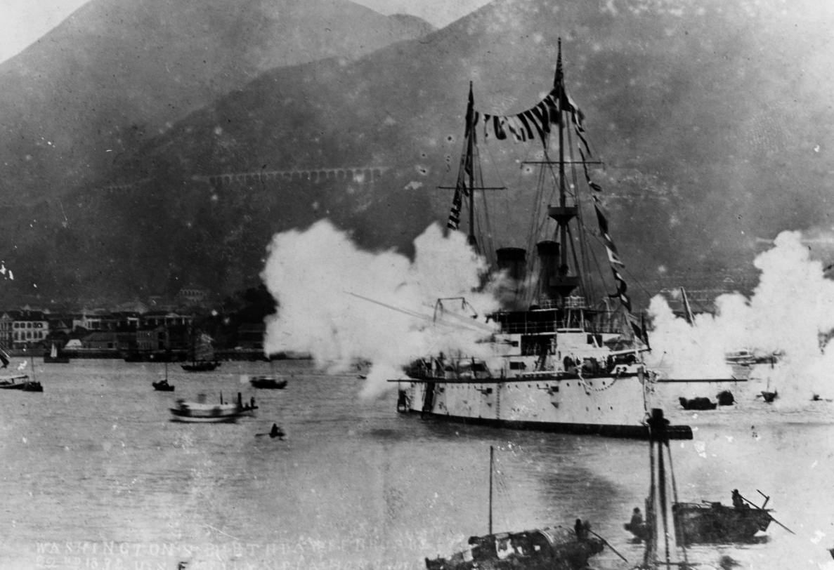A picture of the USS Olympia saluting guns at Hong Kong on Washington's Birthday in 1898.