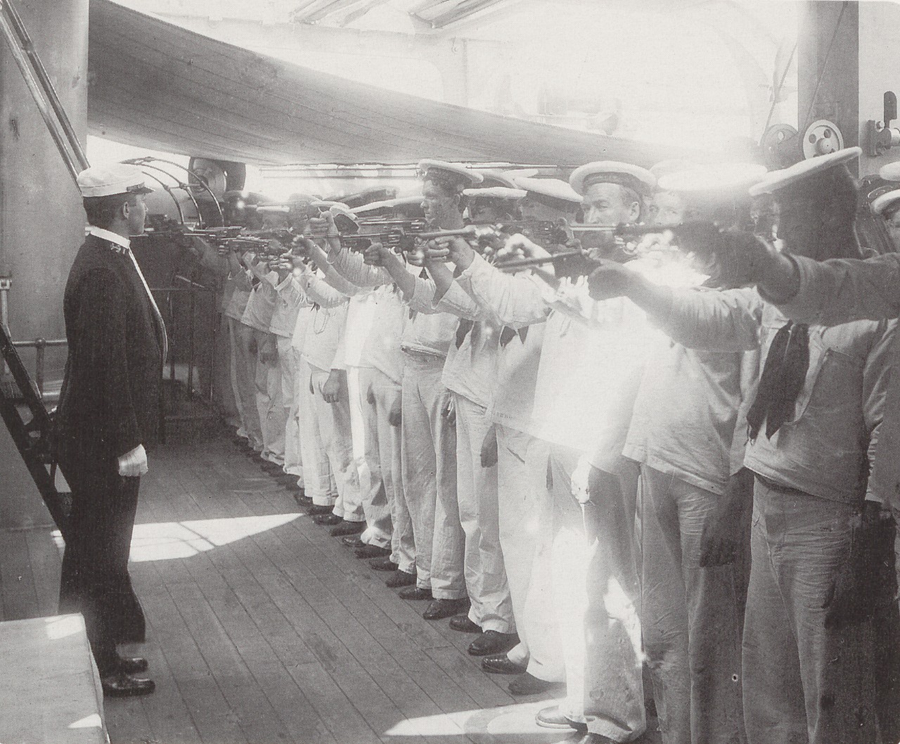 A group of sailors practicing with their pistols on the USS Brooklyn.