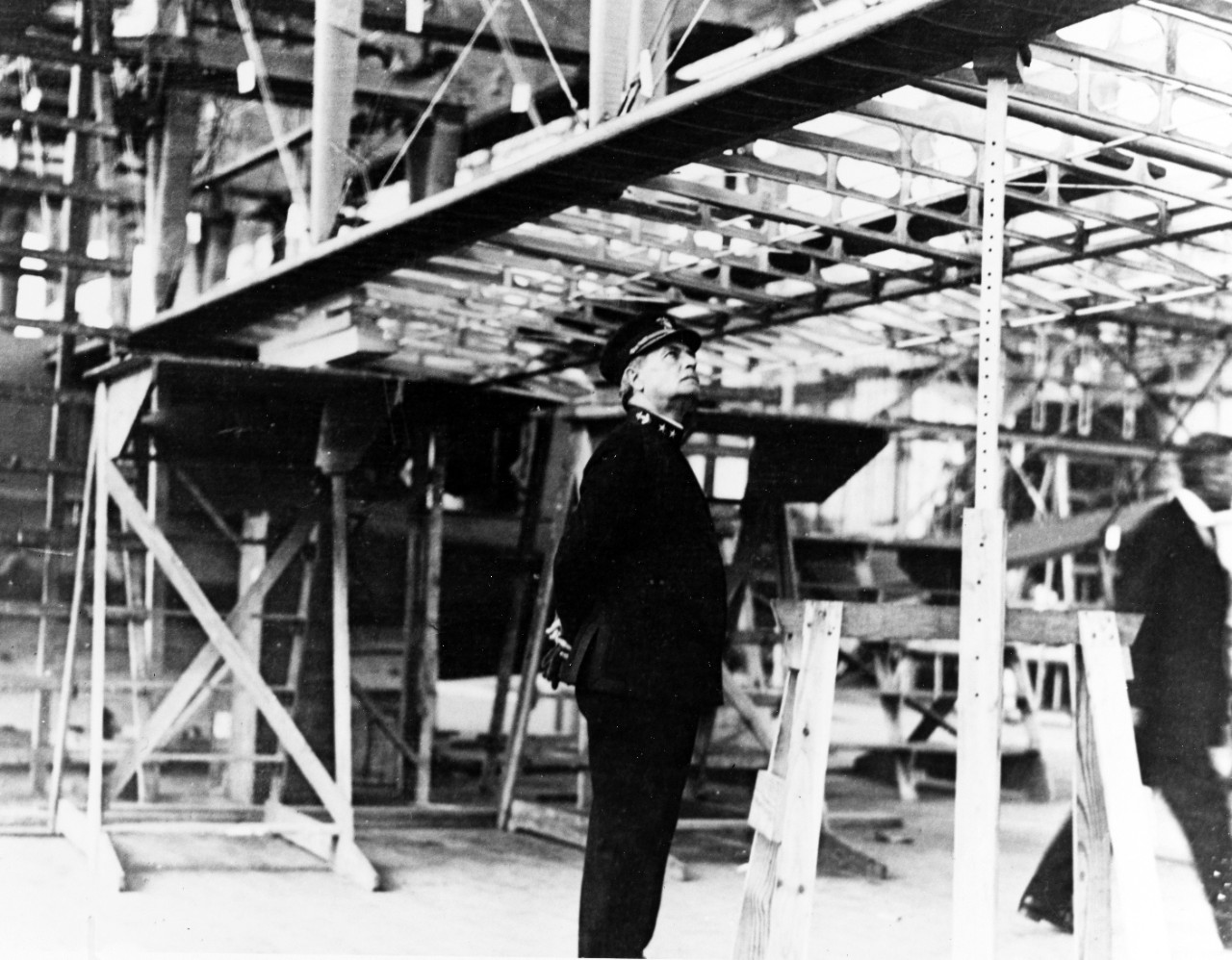Naval officer inspecting aircraft production