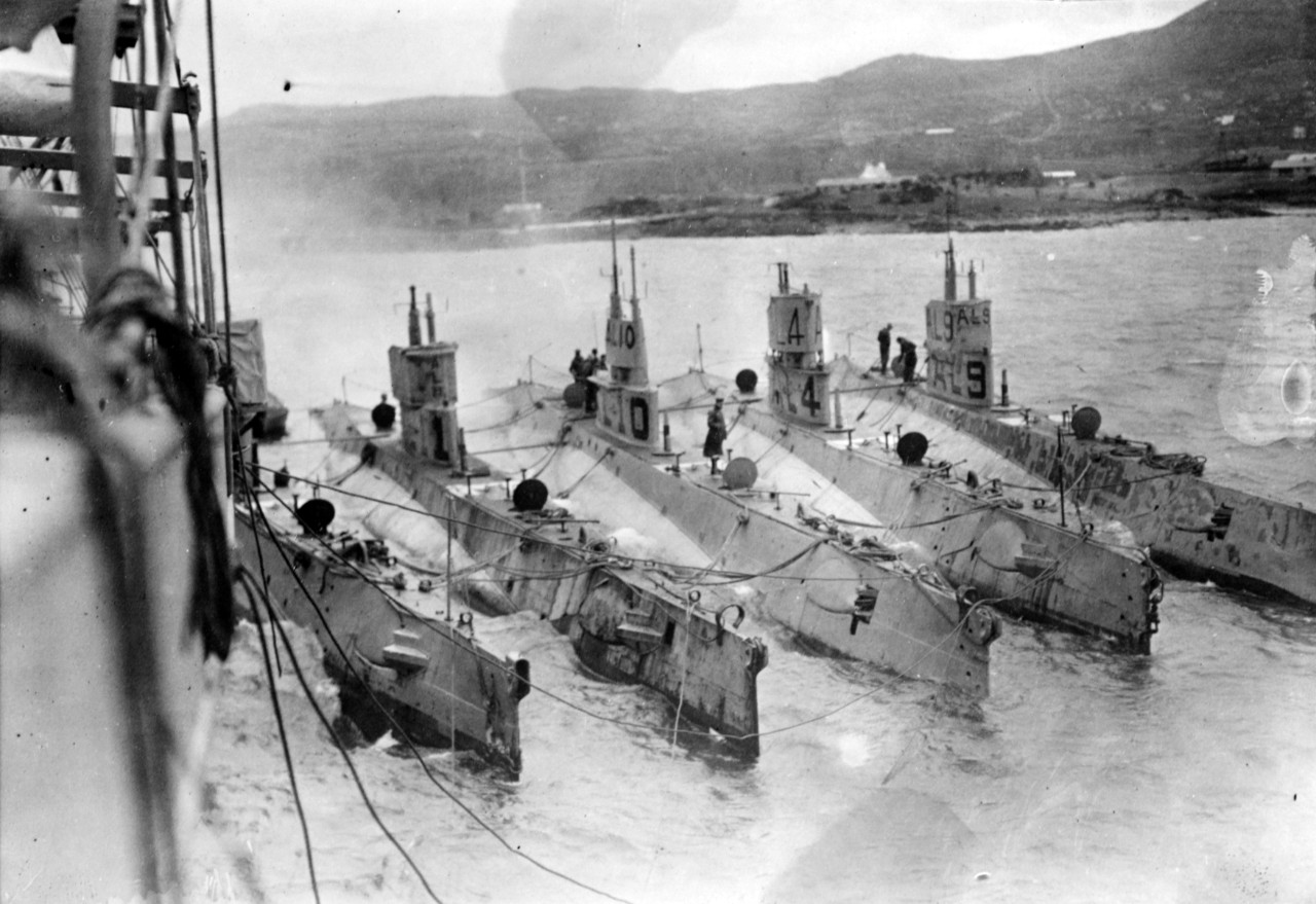 Photograph of submarines alongside a tender