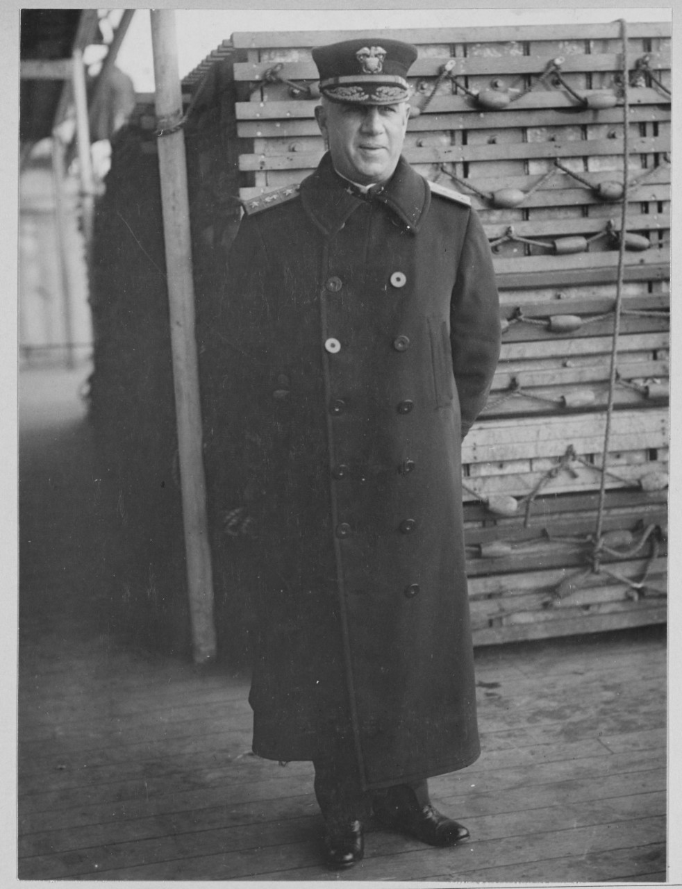 Photograph of Bullard standing in naval uniform and overcoat