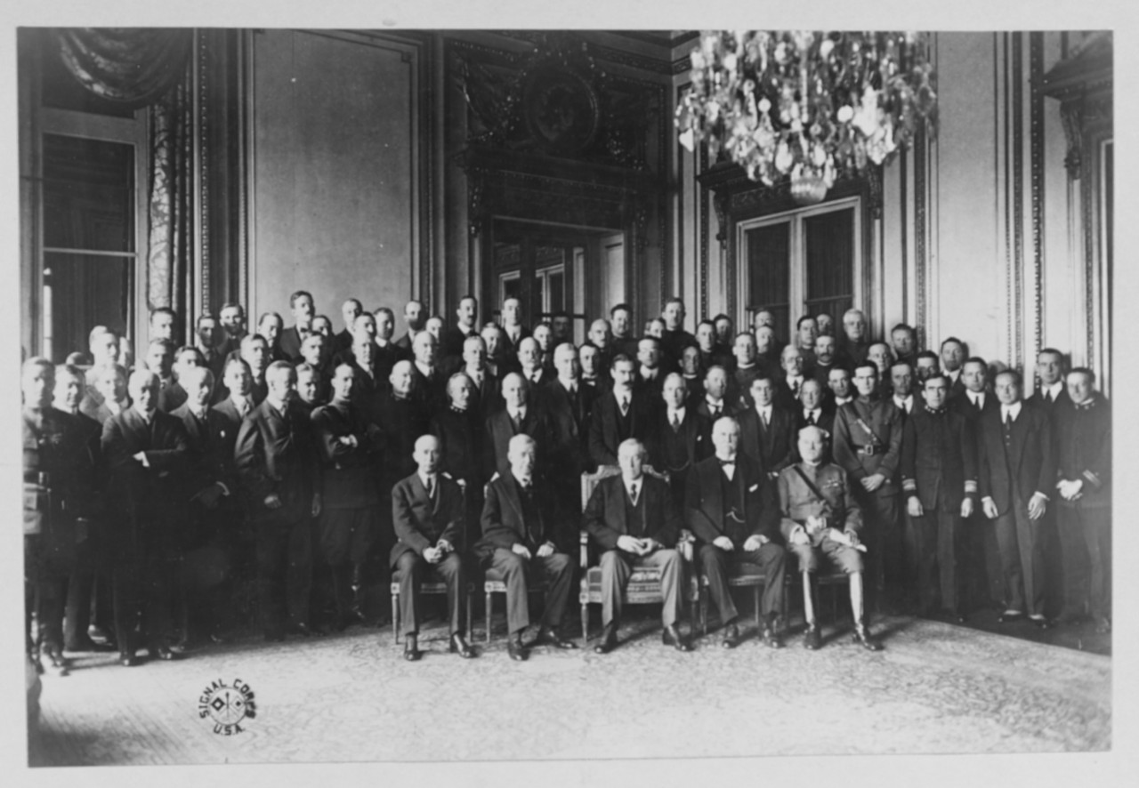 Photograph of a large group of men, with four seated in front