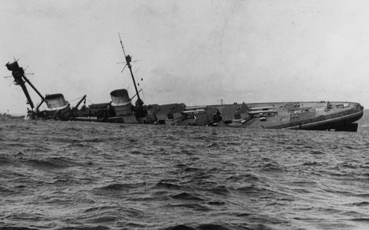 Photograph of ship sinking. Only about 75% of the vessel remains above water