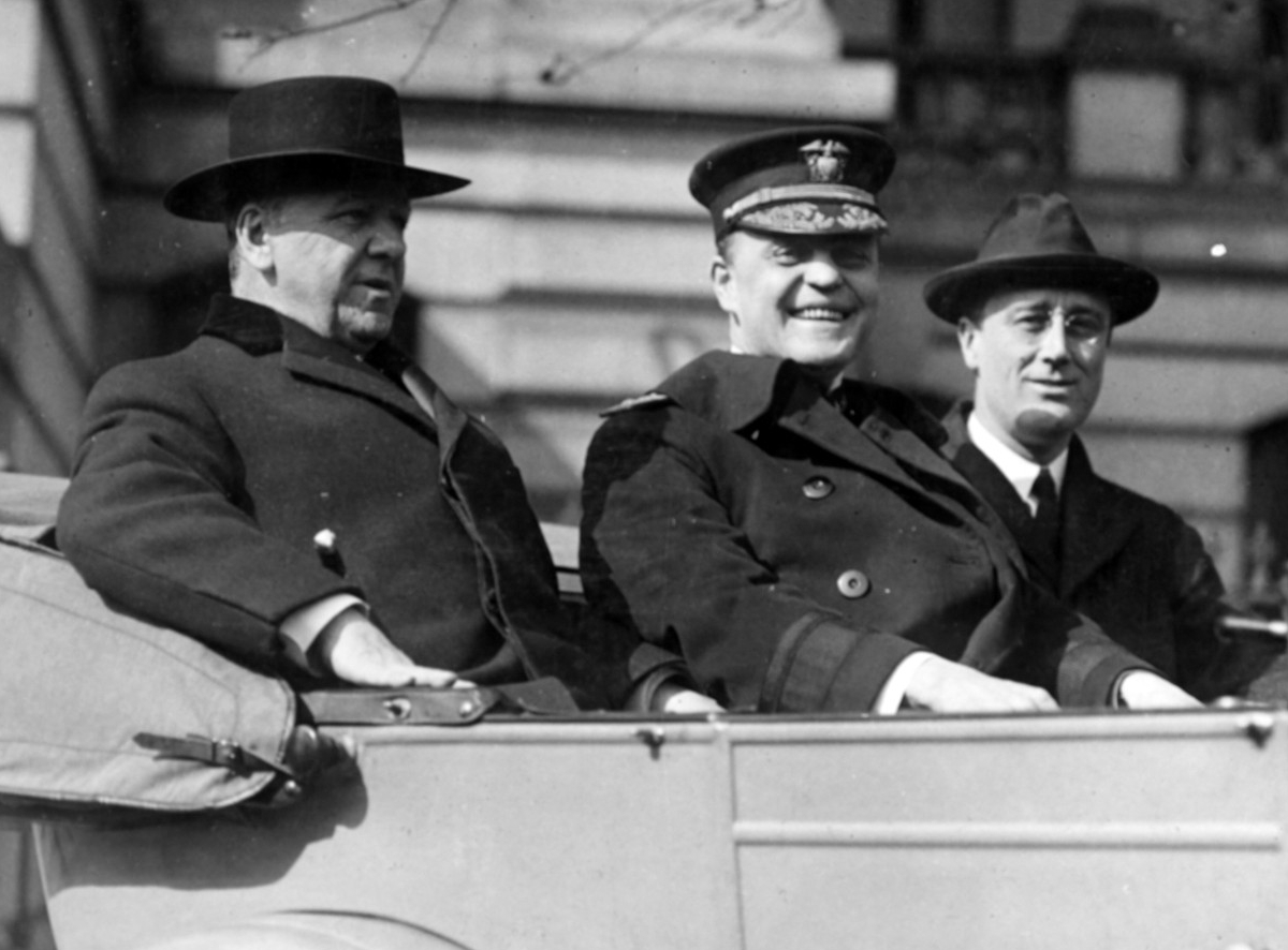 Photograph of all three men in an open car
