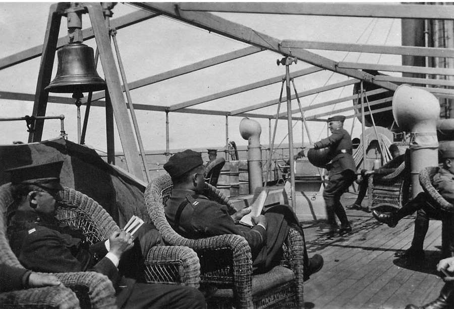 Photograph of officers on deck of a naval transport vessel