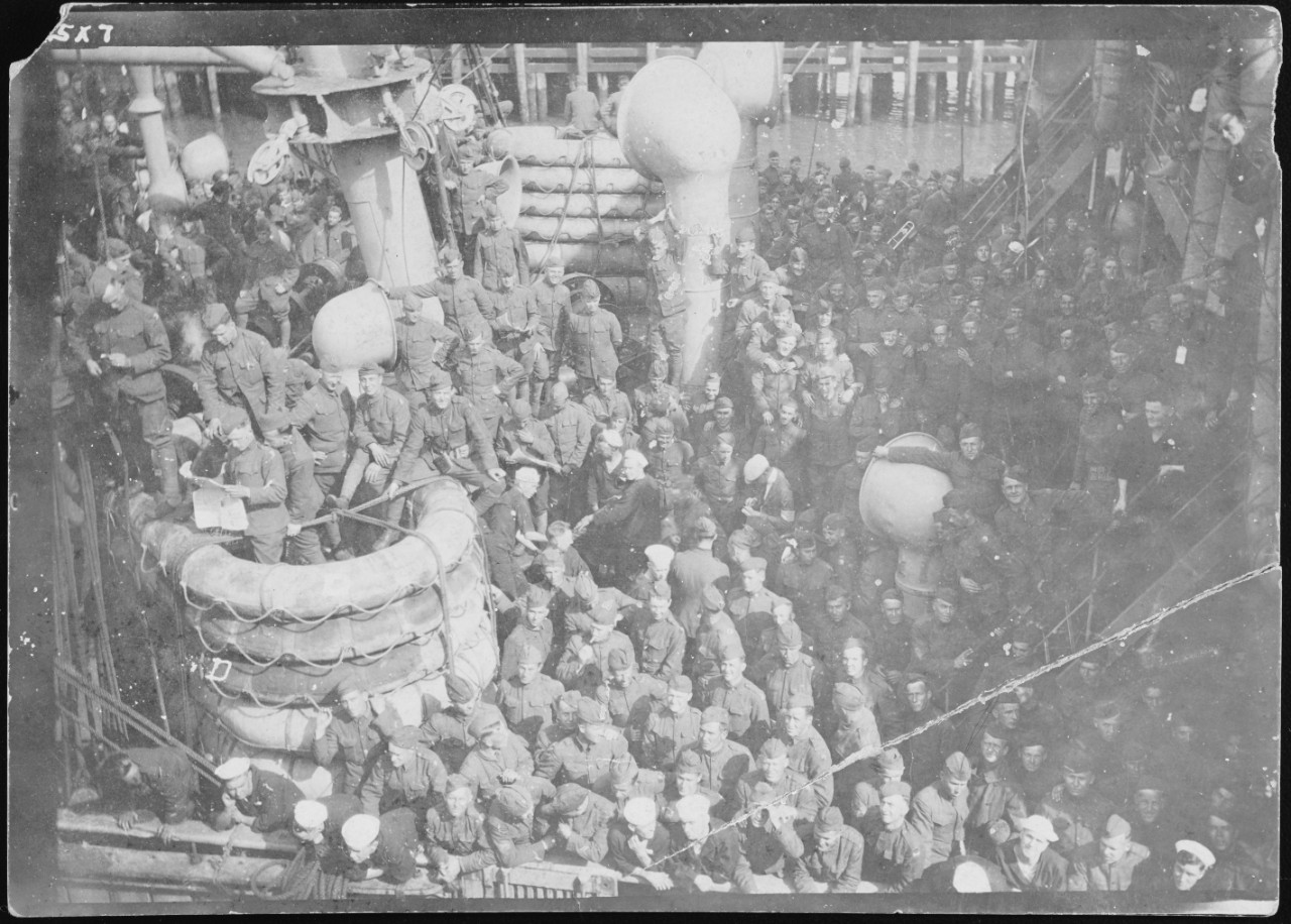 Photograph of a large crowd of soldiers on deck of their trasnport ship
