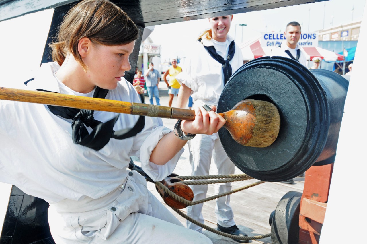 <p>090915-N-9824T-227: USS Constitution, 2009. Seaman Sarah Rickett, assigned to USS Constitution, demonstrates how Sailors in the past would prepare a cannon for firing. The gun drill demonstration by the Constitution crew was one of many Navy events scheduled during York Navy Week, one of 21 Navy Weeks planned across America in 2009. Navy Week is designed to show Americans the investment they have made in their Navy and increase awareness in metropolitan areas that do not have a significant Navy presence. Photographed by MC2 Devin Thorpe. Official U.S. Navy Photograph.</p>
