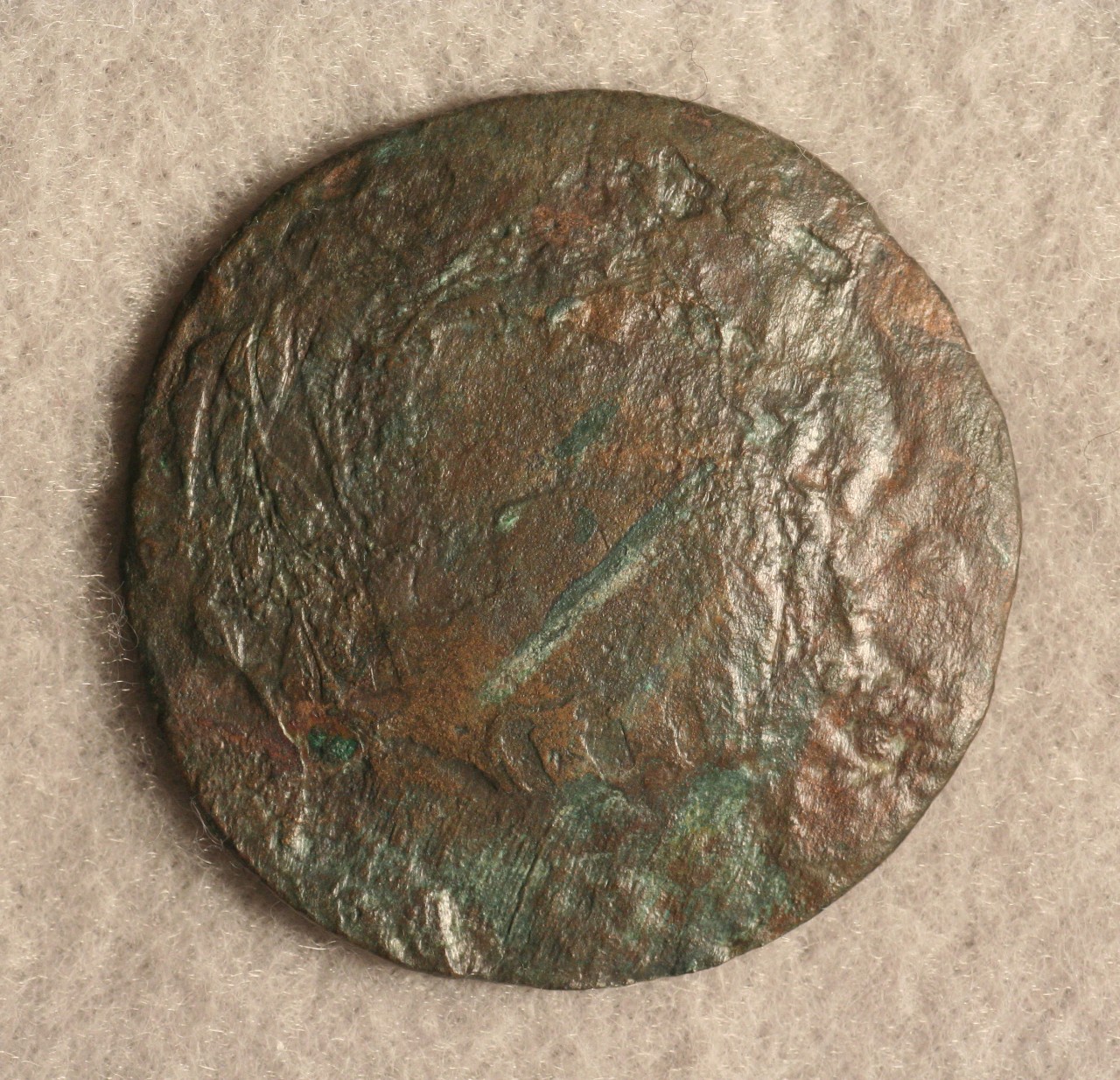 <p>A round bronze Brazilian 40-Reis coin recovered from the CSS Alabama. On the obverse side is a stamped 40 in the center with a ring of garland around it and below the 40 is faded letters “RUS.I. D.C. CON”. This coin was produced during the reign of King Pedro I of Brazil.</p>